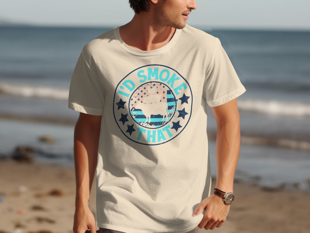 Cream t-shirt with "I'd Smoke That" graphic featuring a cow and American flag design.