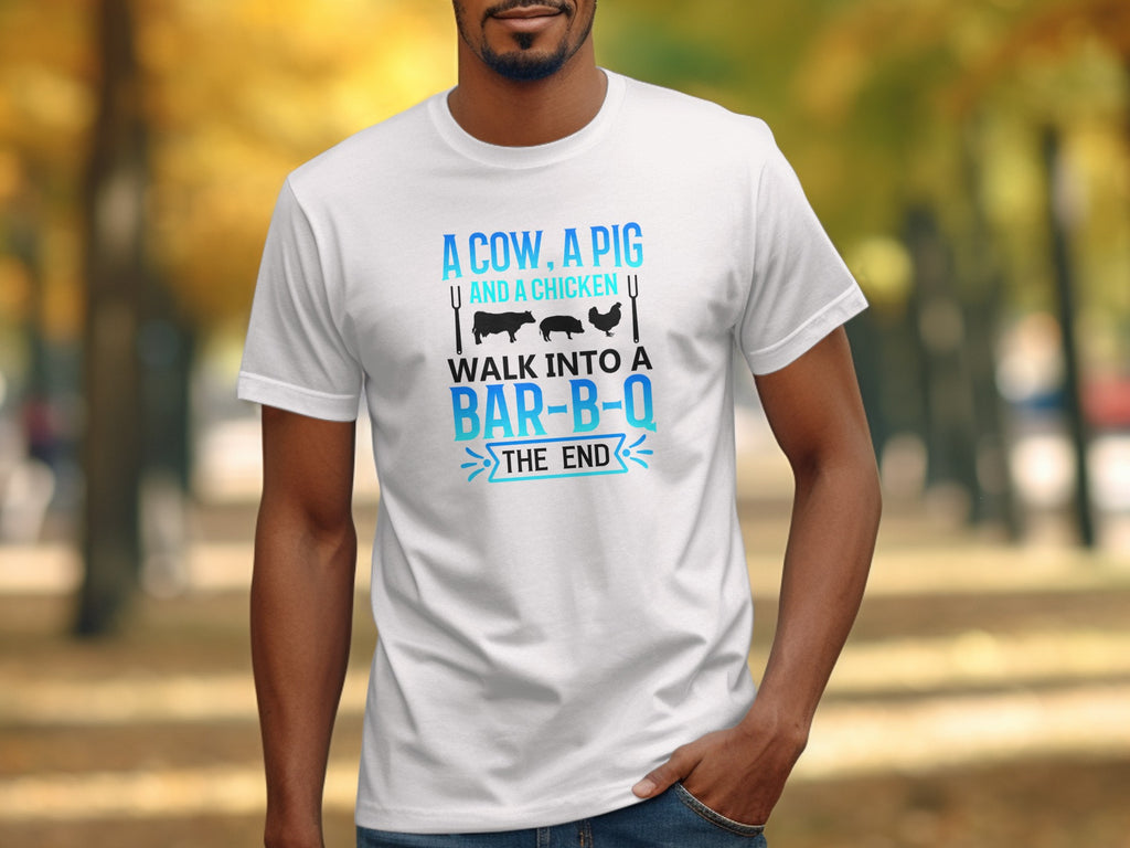 White t-shirt with graphic featuring text "A cow, a pig and a chicken walk into a bar-b-q the end."