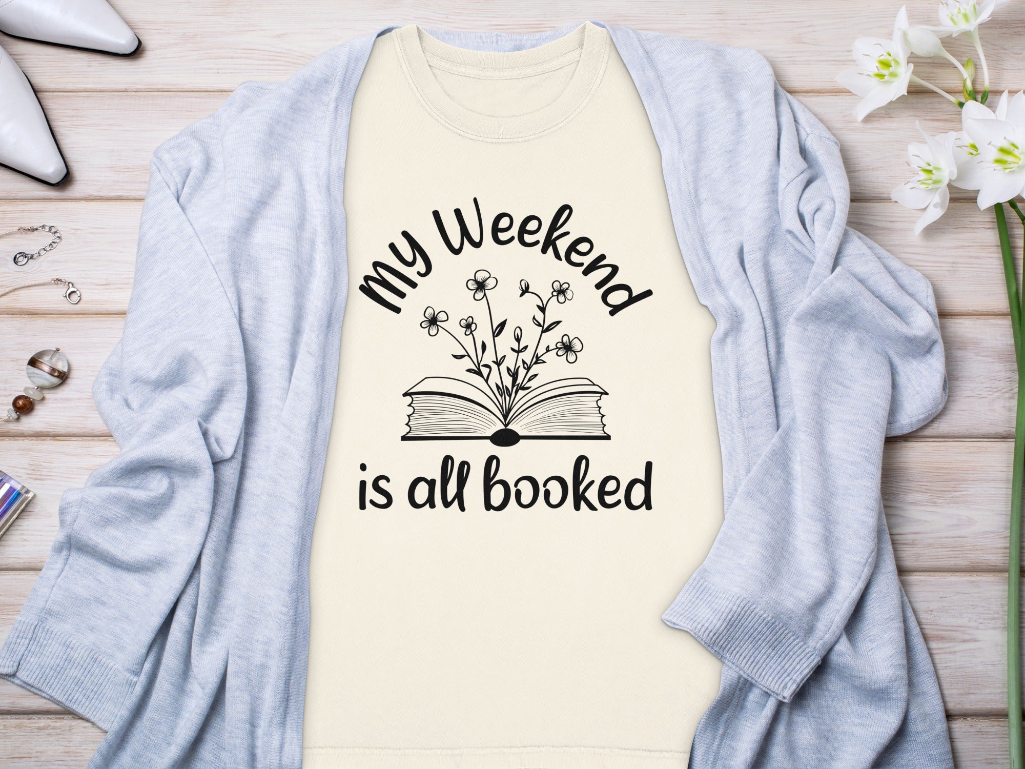 Cream t-shirt with black text and graphic reading "my Weekend is all booked".