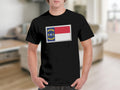 Black t-shirt with a North Carolina flag design inside a stamp outline.