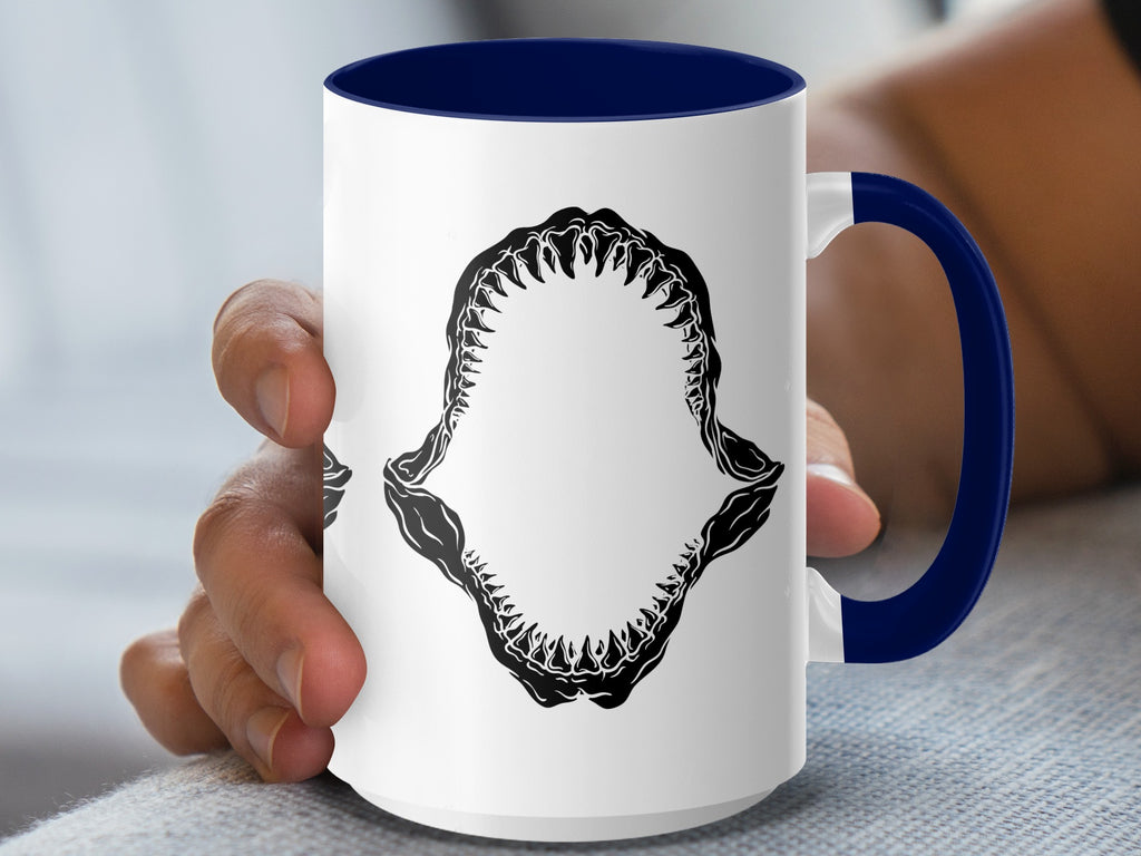 White mug with blue handle and interior, featuring black shark jaws graphic.