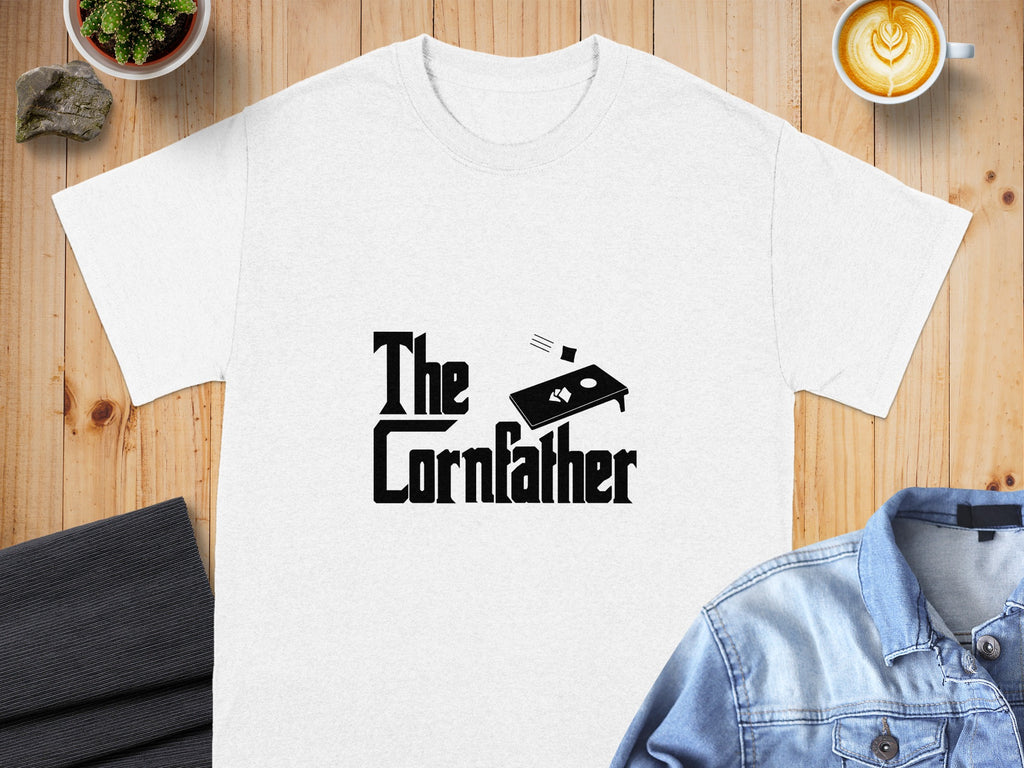 White t-shirt with black text and cornhole graphic reading "The Cornfather".