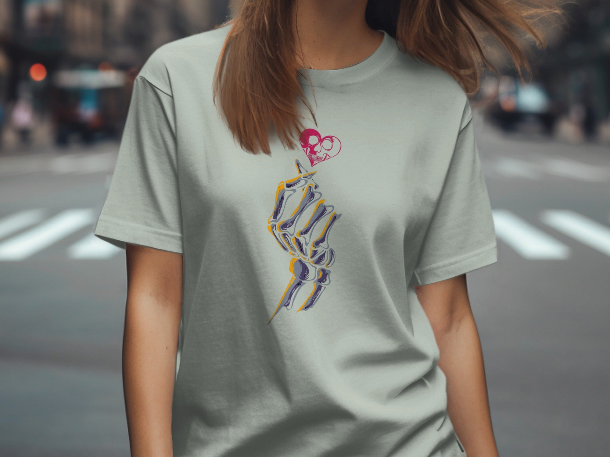 Light gray t-shirt featuring a skeleton hand with a pink skull heart.