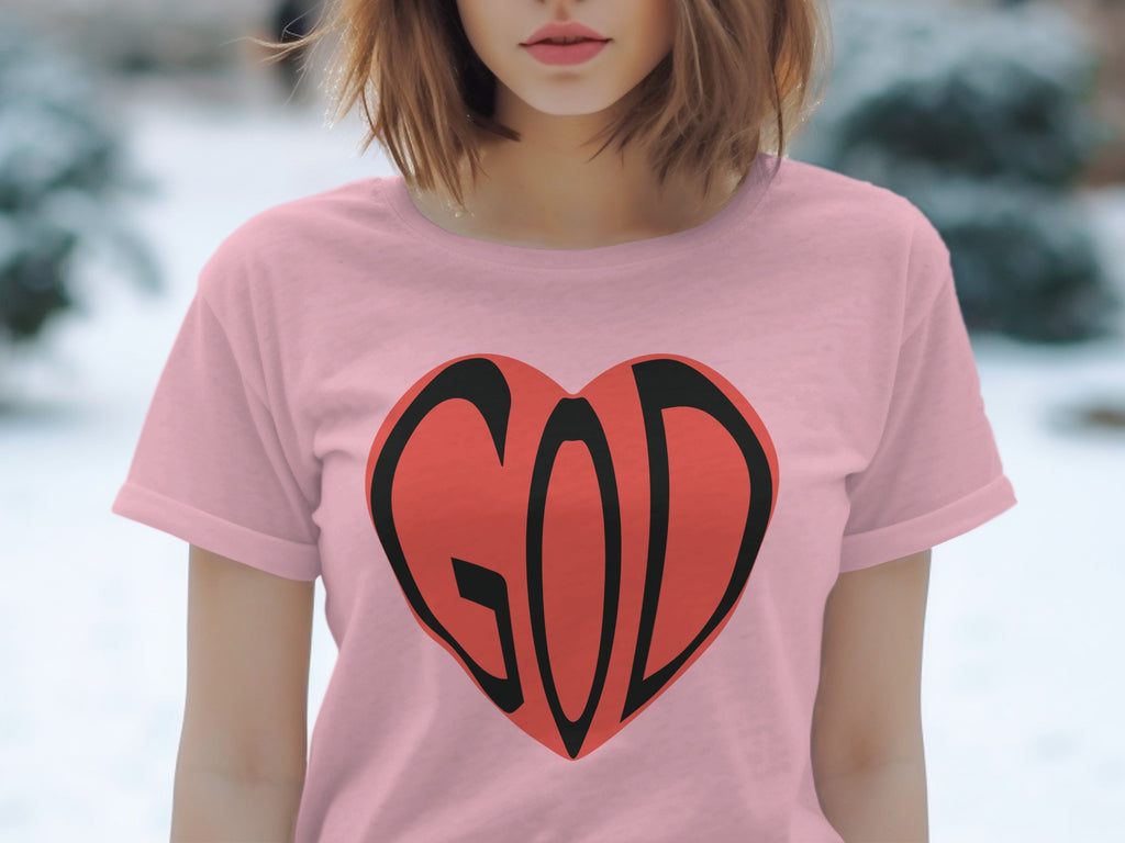 Pink t-shirt with a red heart graphic featuring the word "GOD" in black.