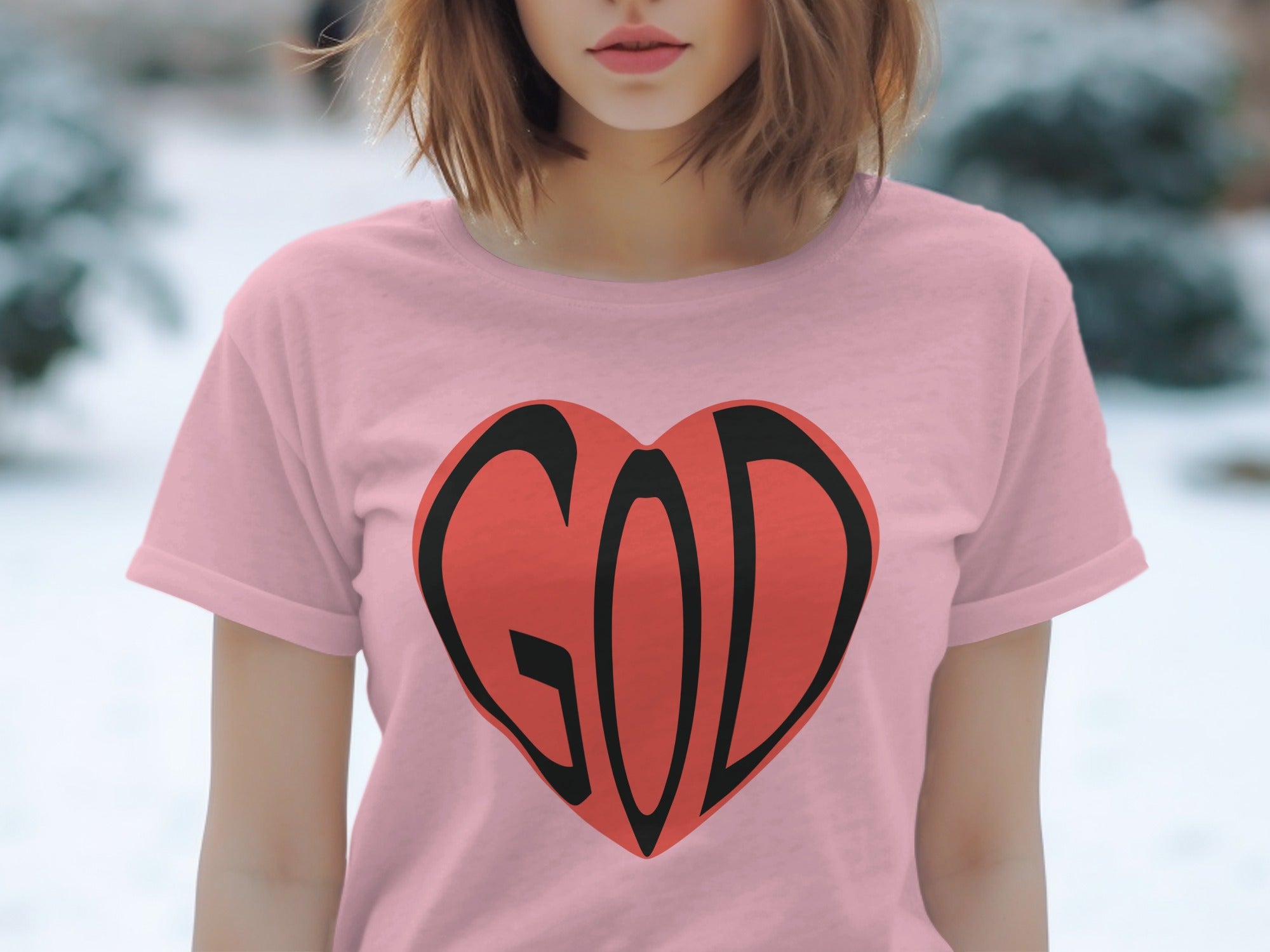 Pink t-shirt with a red heart graphic featuring the word "GOD" in black.