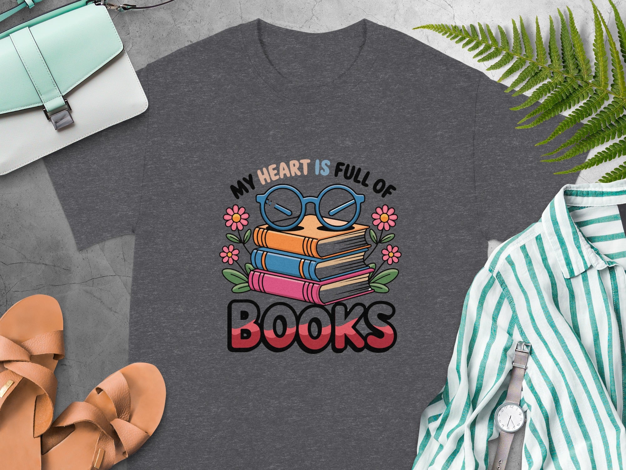 "My Heart Is Full of Books" text with stacked books and glasses graphic on t-shirt.