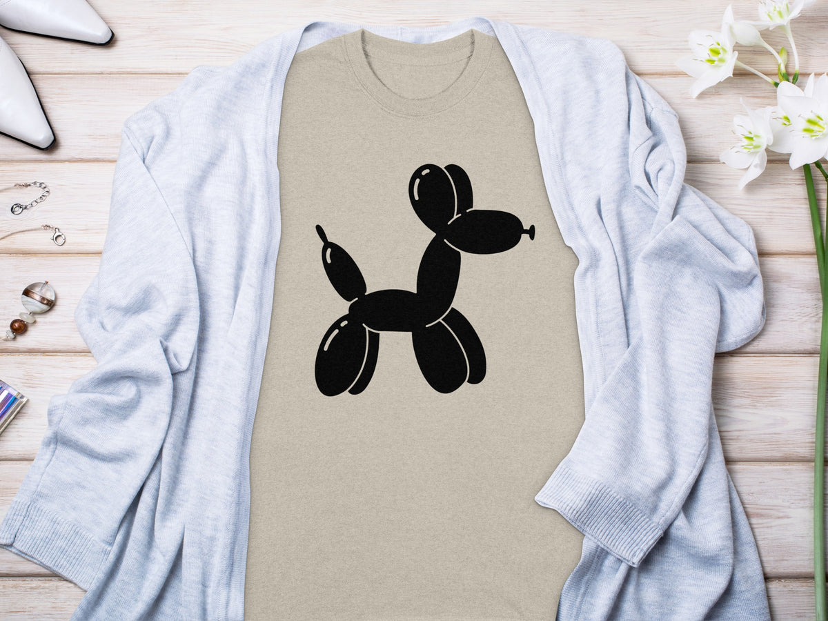 Tan t-shirt with black balloon dog graphic, draped with a light blue cardigan.