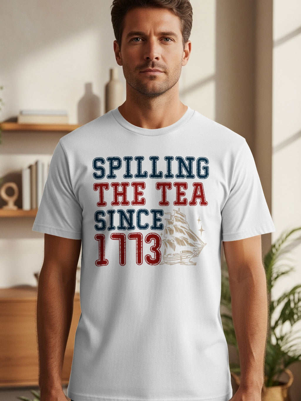 White t-shirt with navy and red text "Spilling The Tea Since 1773" above a ship graphic.