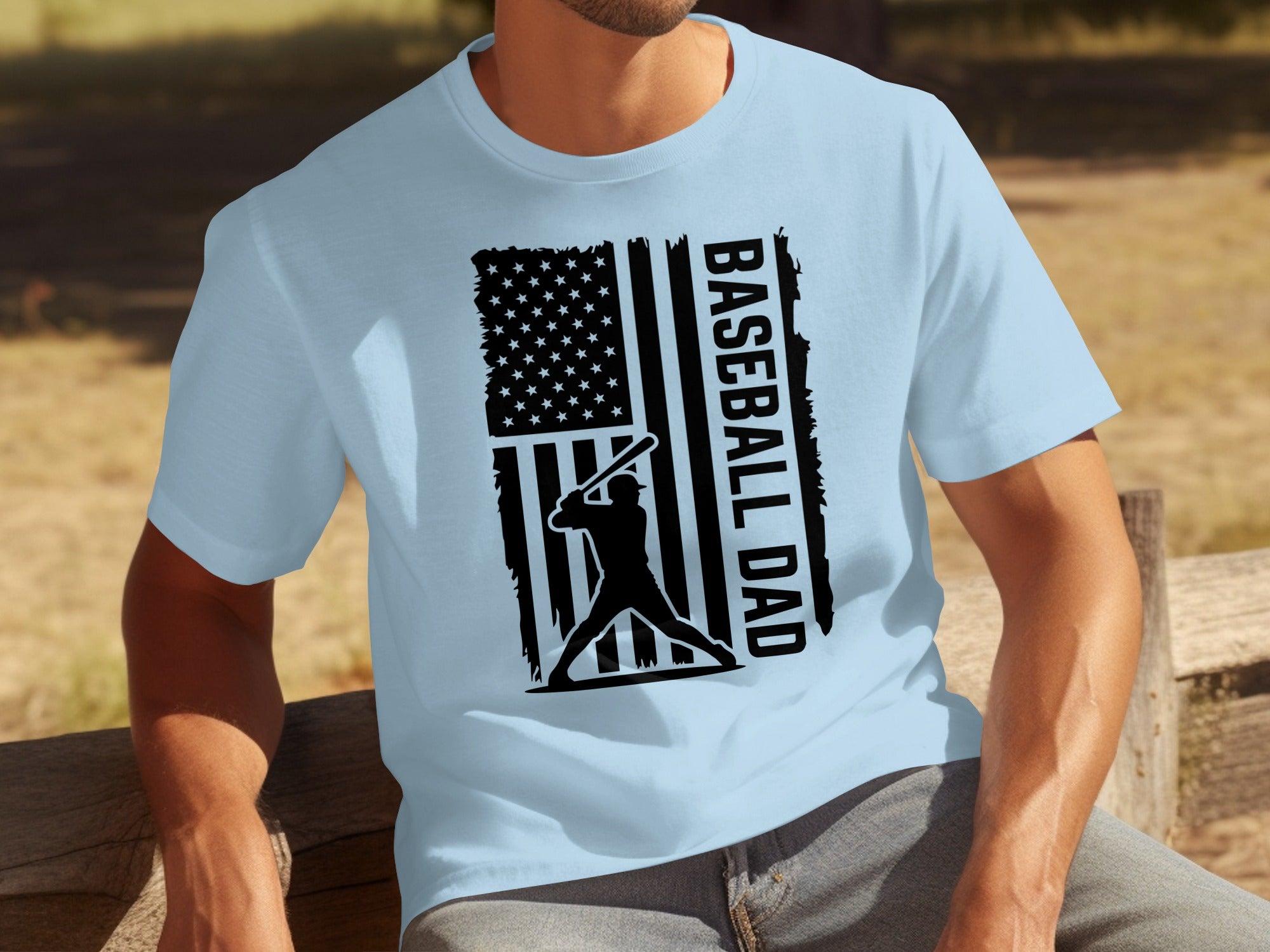 Light blue t-shirt with black graphic of baseball player and text BASEBALL DAD.