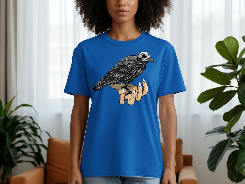 Blue t-shirt with a raven skeleton sitting on a hand graphic.