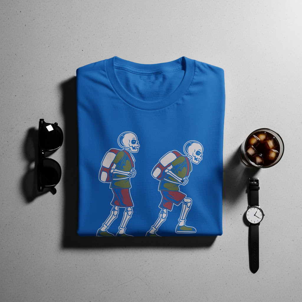 Blue t-shirt with cartoon skeletons wearing backpacks and shorts.