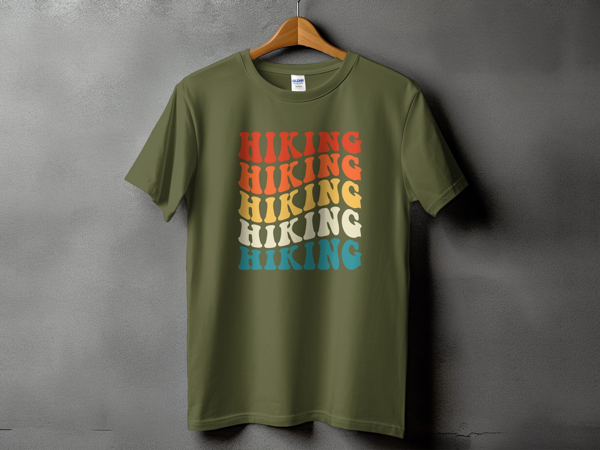Olive green t-shirt with the word "Hiking" in stacked, wavy, retro lettering.
