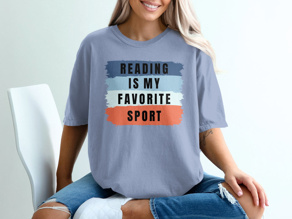 T-shirt with text "Reading is my favorite sport" in black on color blocks.