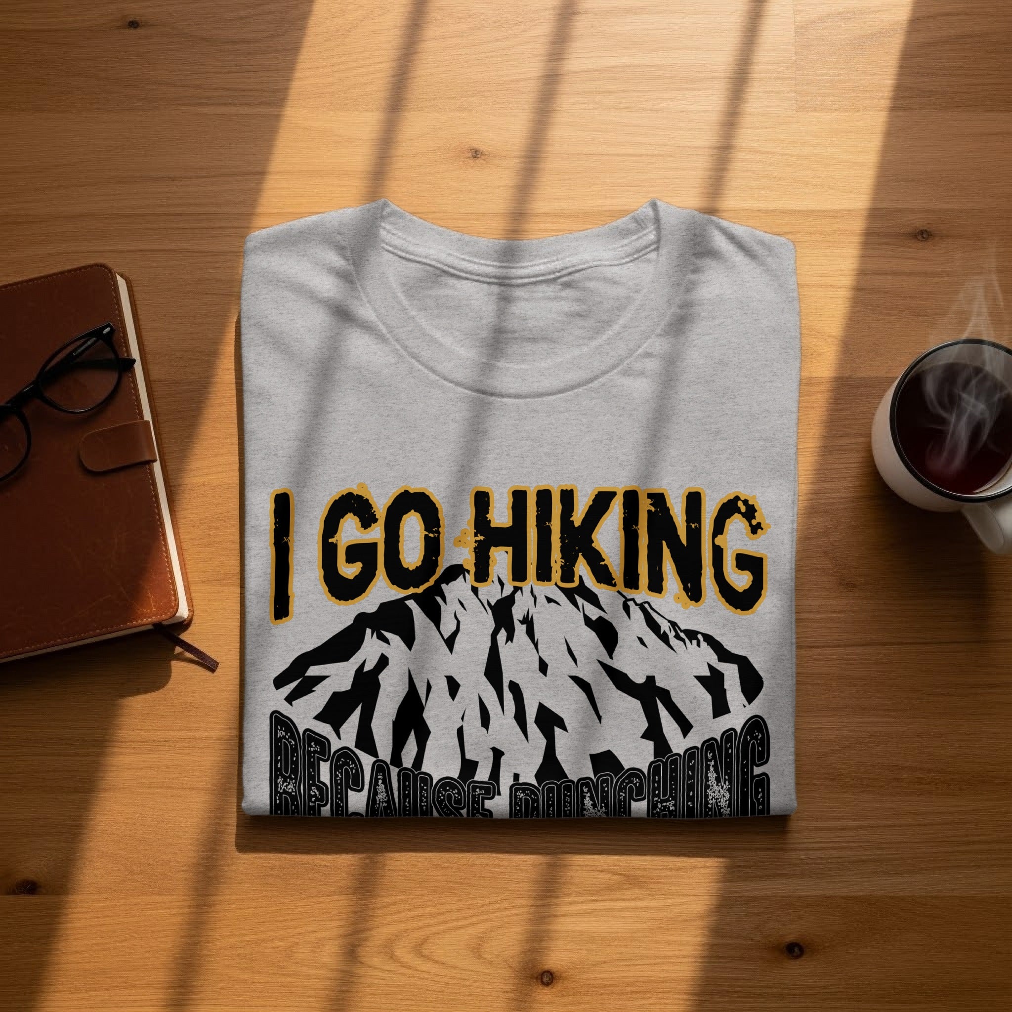 Gray t-shirt with "I Go Hiking Because Munching" text and mountain graphic.