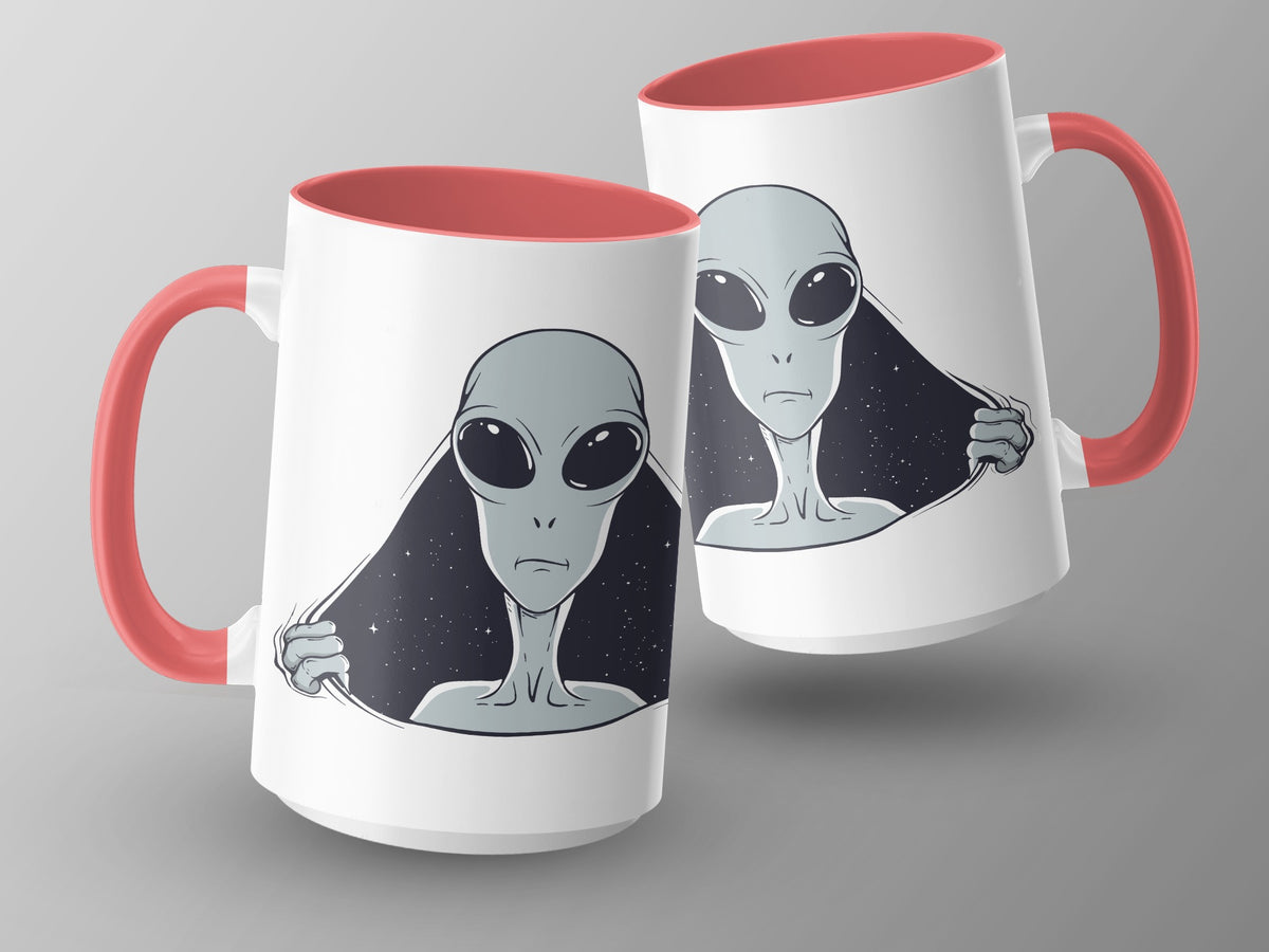 Two white mugs with coral handles, featuring a gray alien design with a starry background.