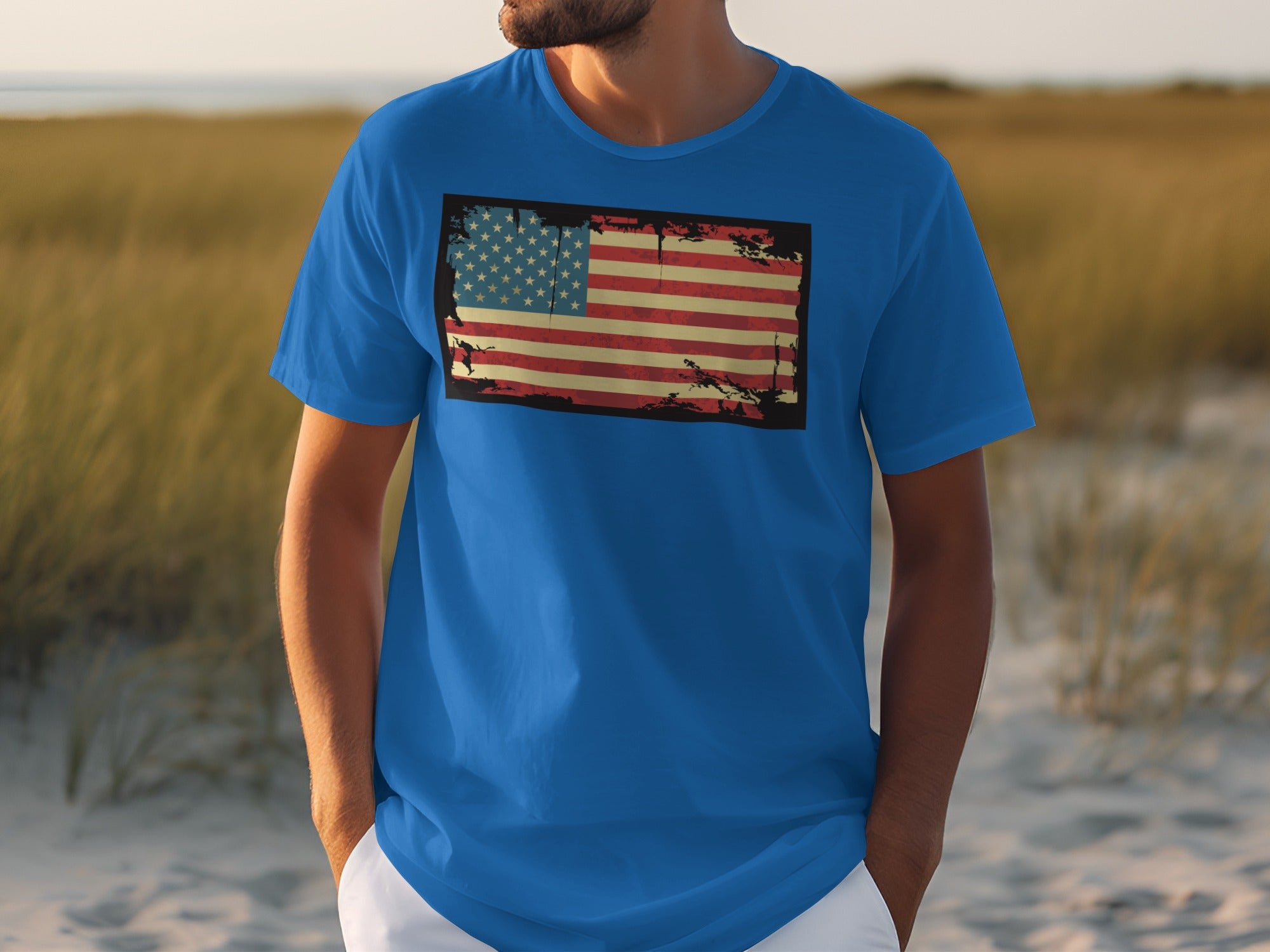 Man wearing blue t-shirt with distressed American flag graphic on the chest.
