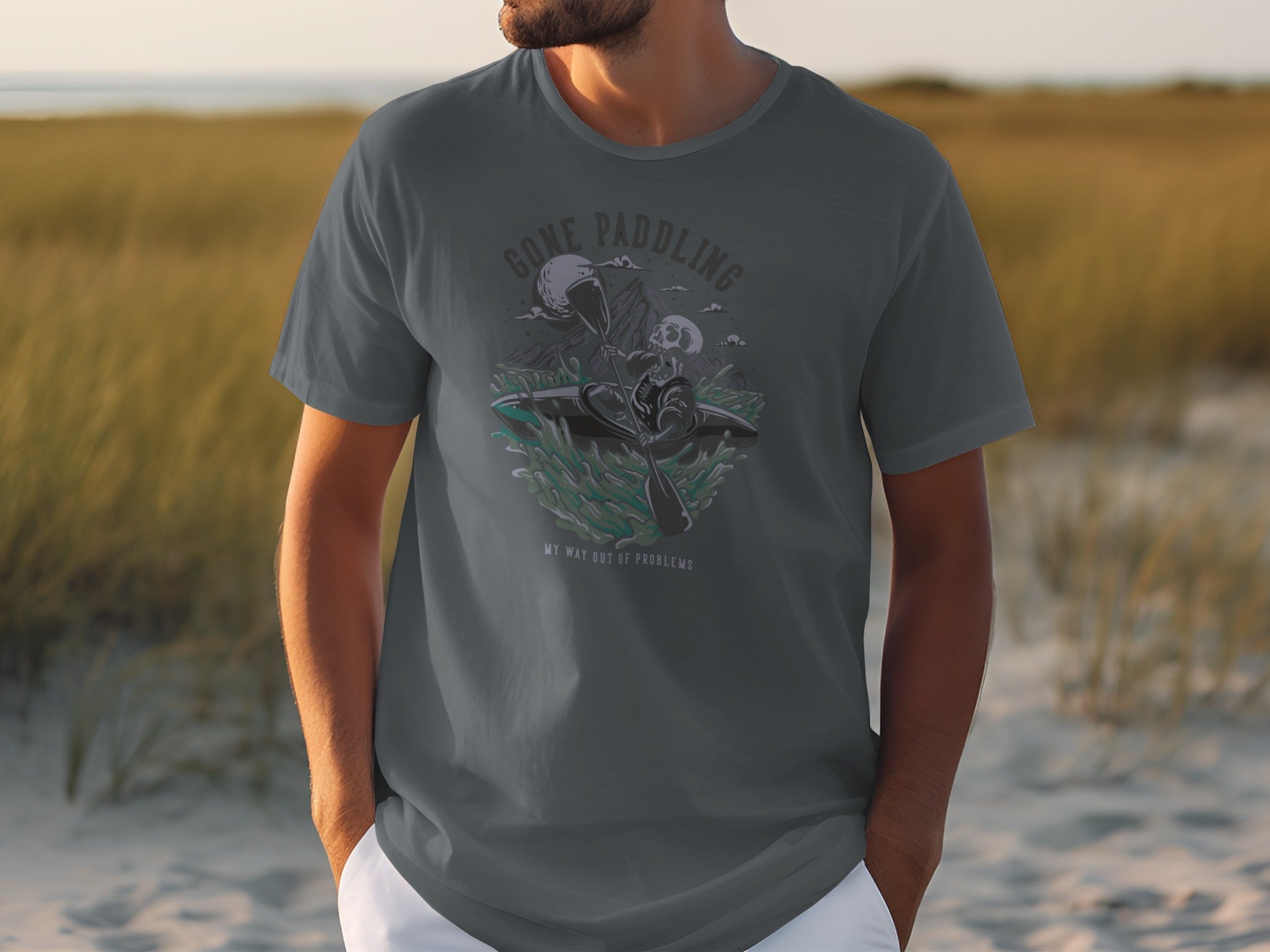 Dark grey t-shirt with graphic of skeleton kayaking with text "Gone Paddling" and "My Way Out of Problems".