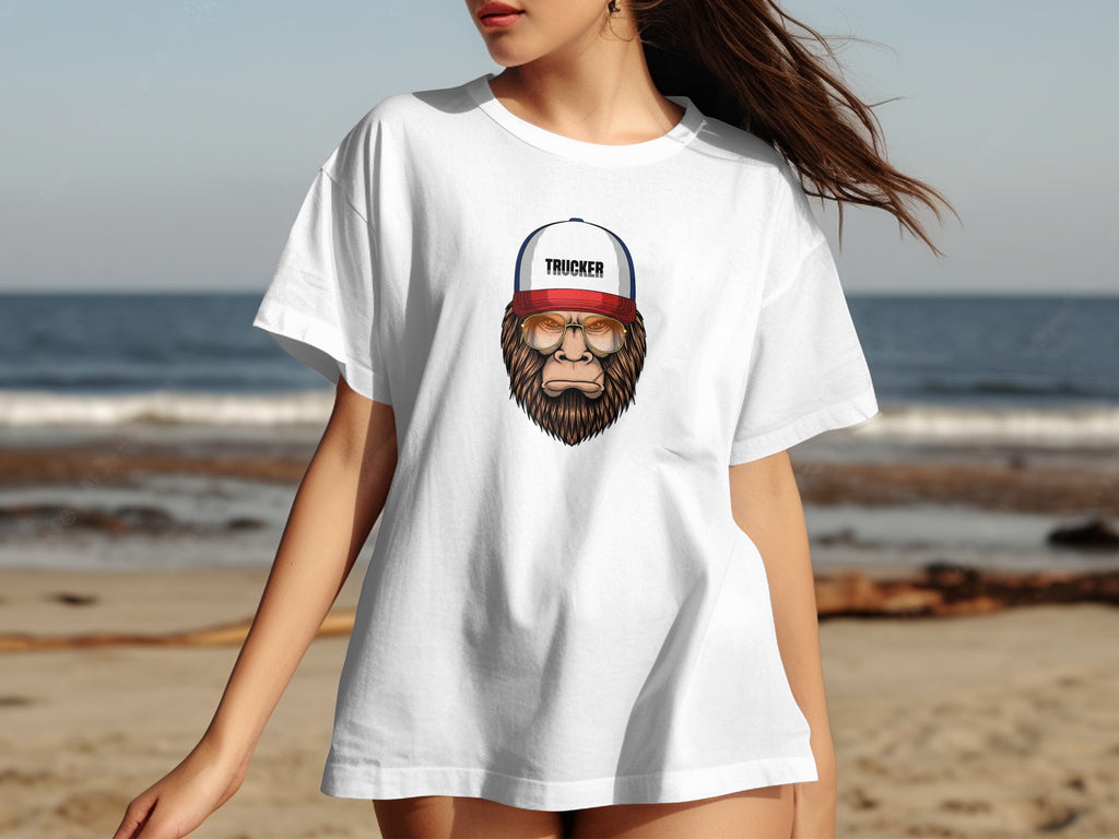 White t-shirt with illustration of a trucker Bigfoot wearing glasses and a hat.