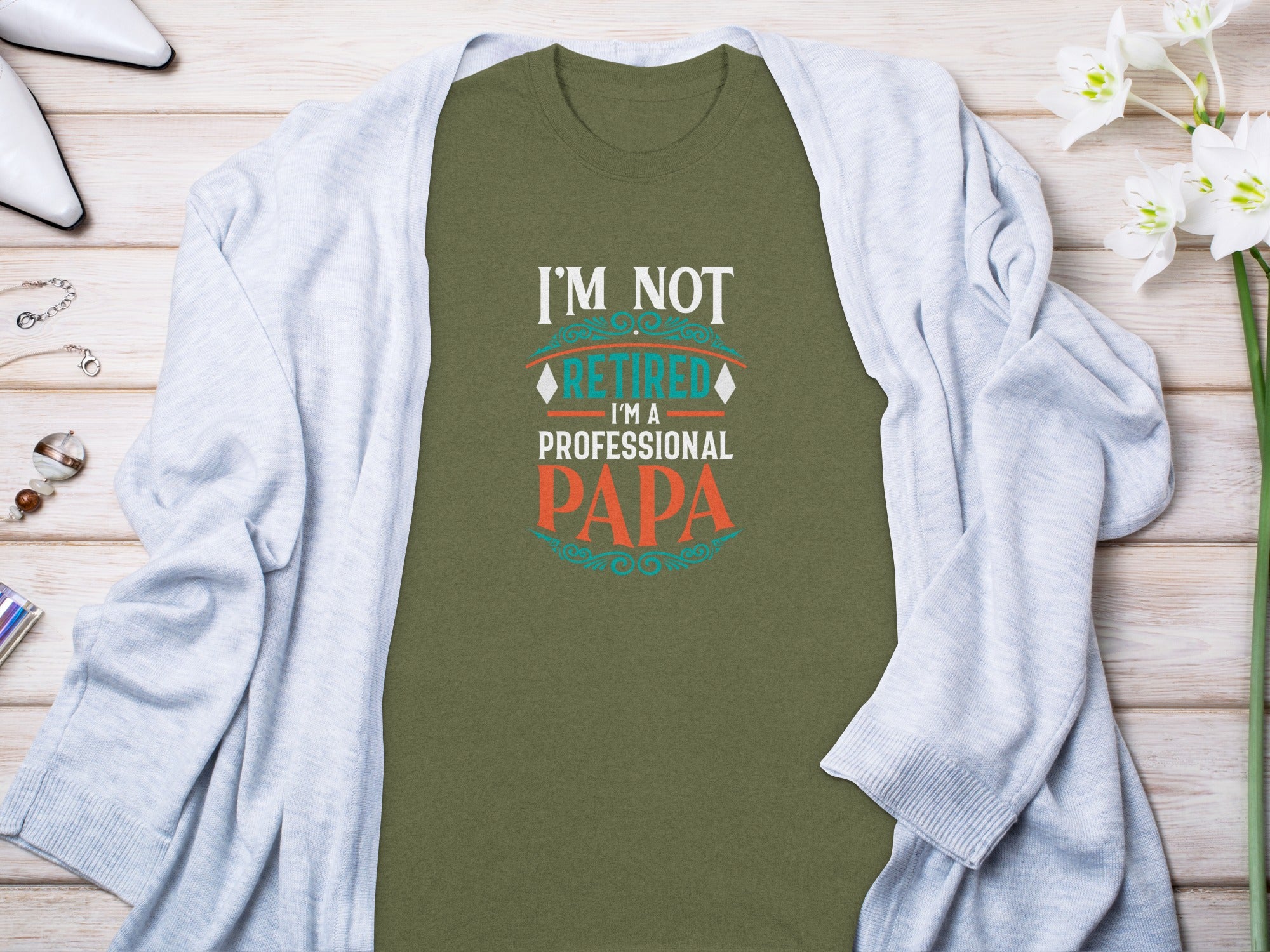 Olive green t-shirt with "I'M NOT RETIRED I'M A PROFESSIONAL PAPA" text.