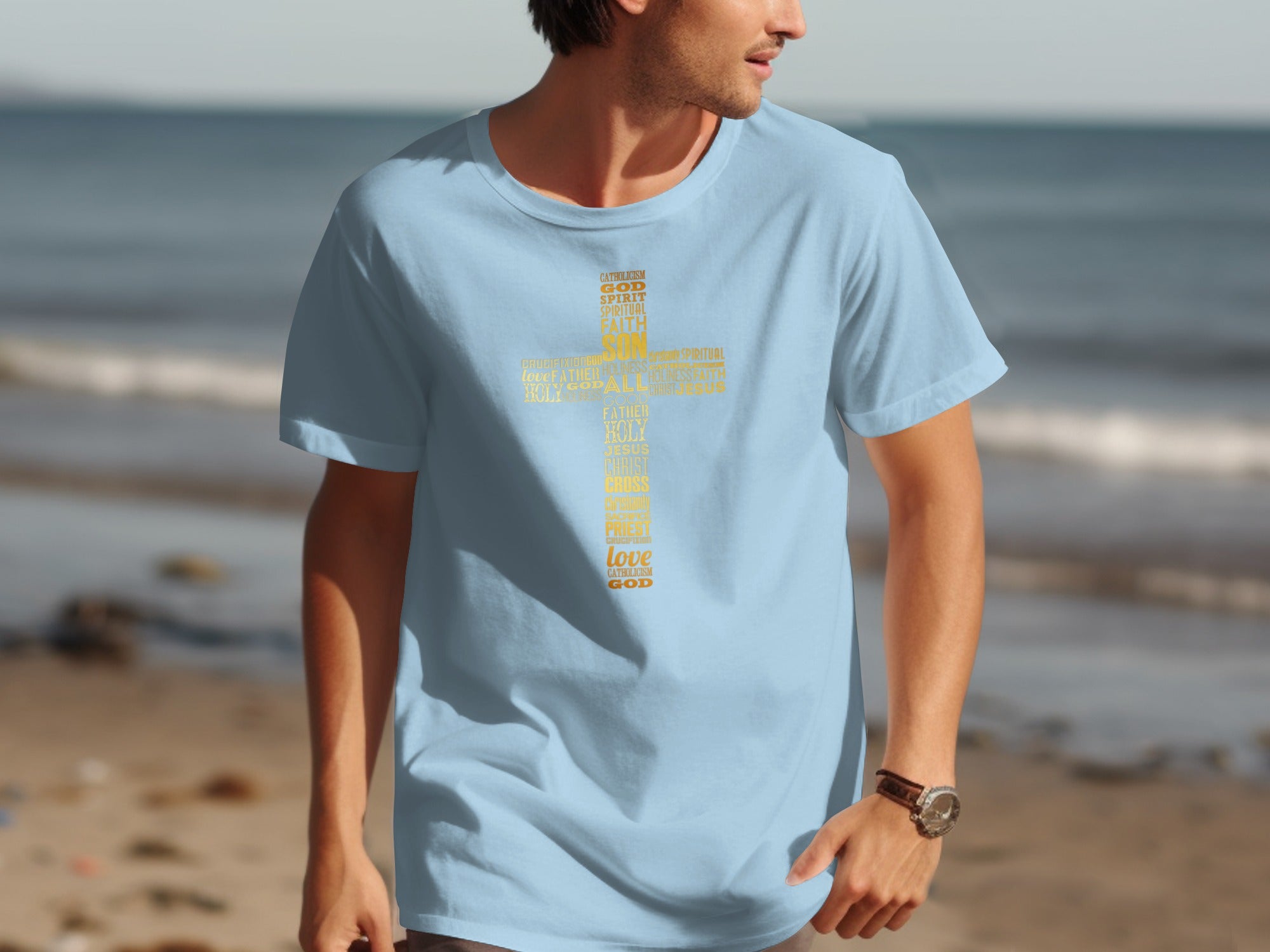 Light blue t-shirt with yellow text forming a cross: Catholicism, God, Spirit, Faith, Son, Jesus.