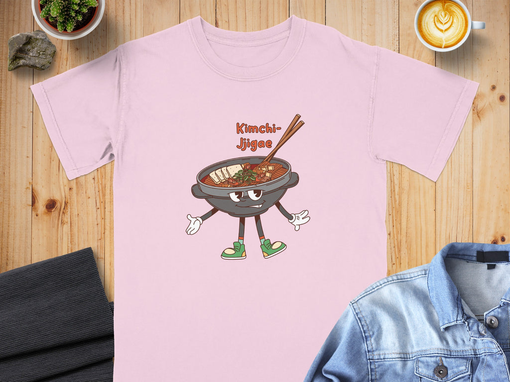 Pink t-shirt with cartoon Kimchi Jjigae graphic and text.