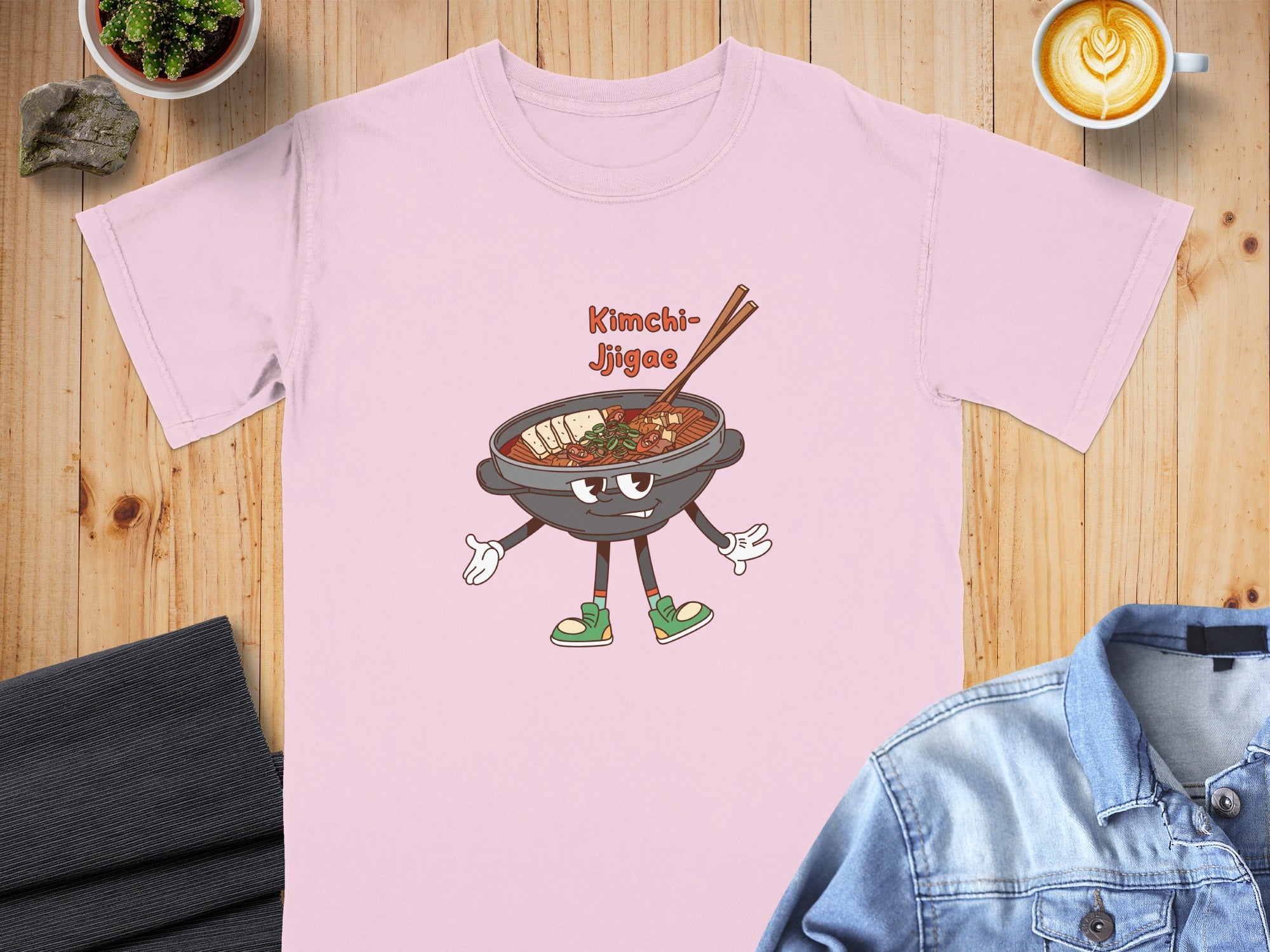 Pink t-shirt with cartoon Kimchi Jjigae graphic and text.