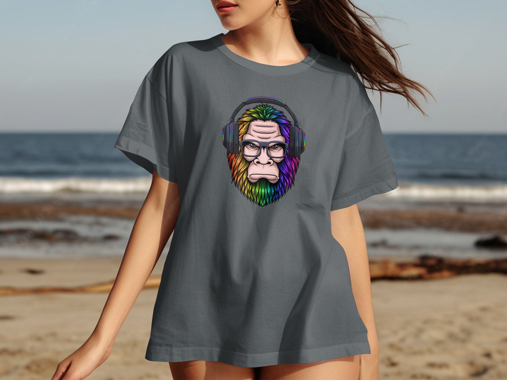 Grey t-shirt with colorful Bigfoot wearing headphones and glasses graphic.