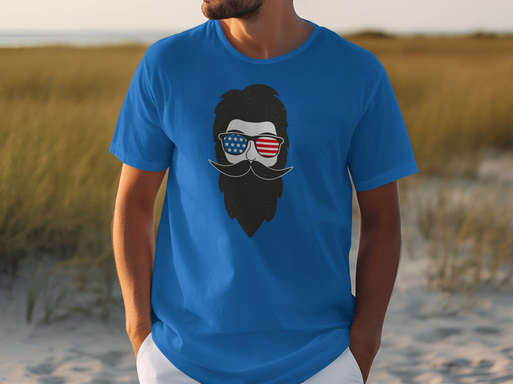 Blue t-shirt with a graphic of a bearded man in patriotic sunglasses.