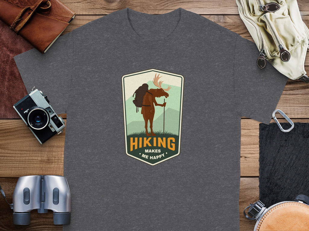 Dark grey t-shirt with a shield emblem featuring a moose hiking and text "Hiking Makes Me Happy".