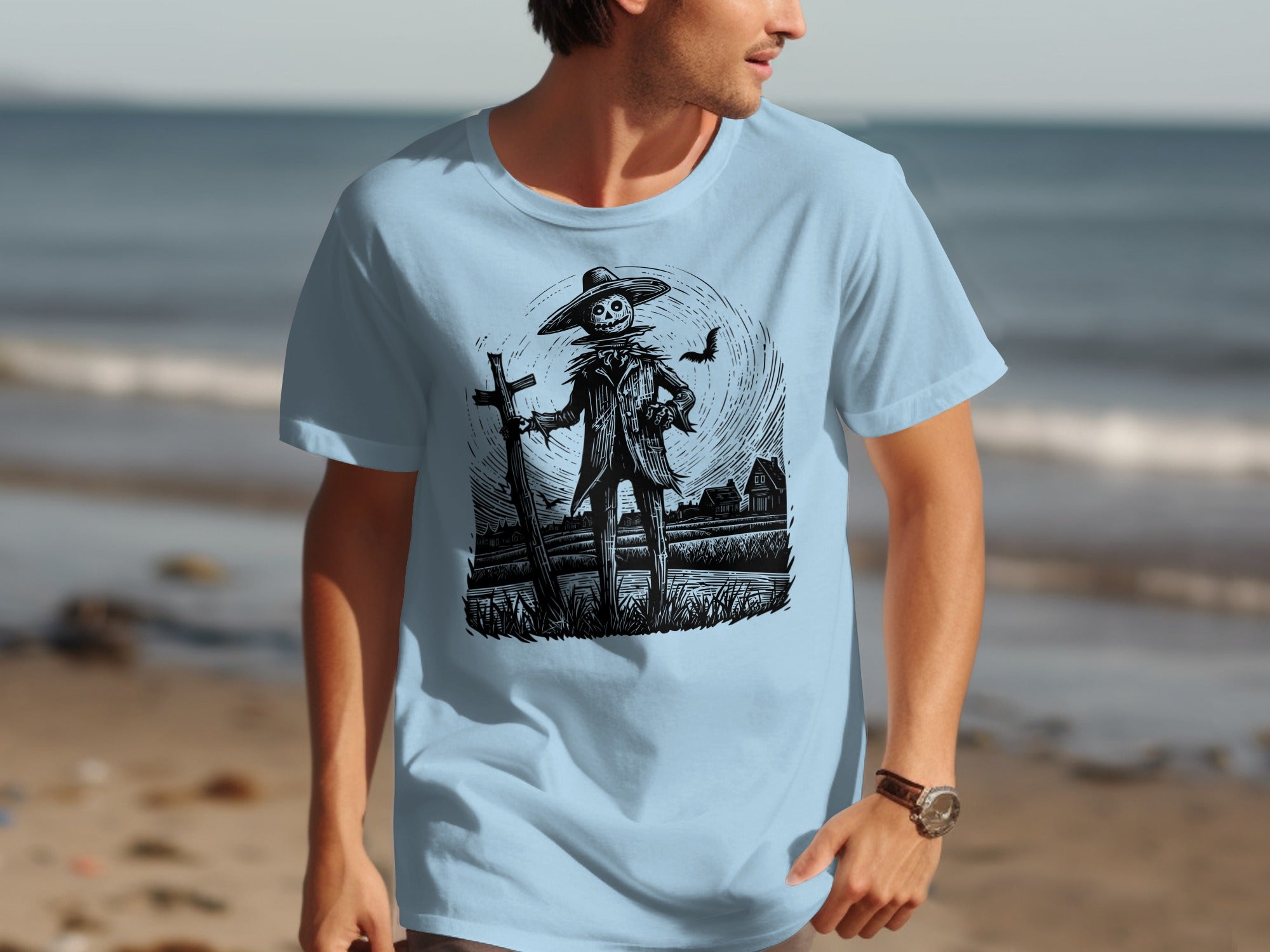 Black and white scarecrow illustration with bat on light blue t-shirt foreground.