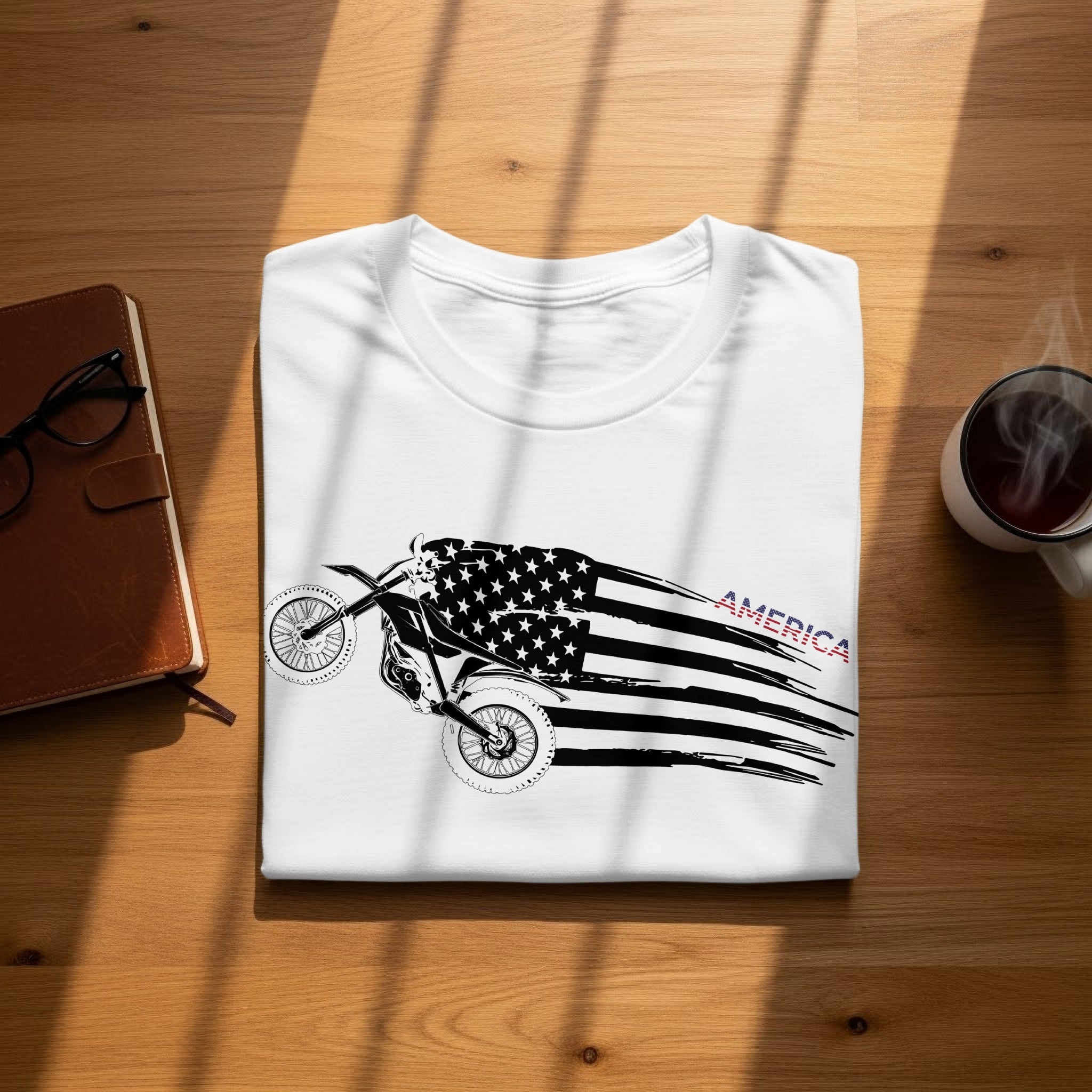 White t-shirt with a dirt bike and American flag graphic.