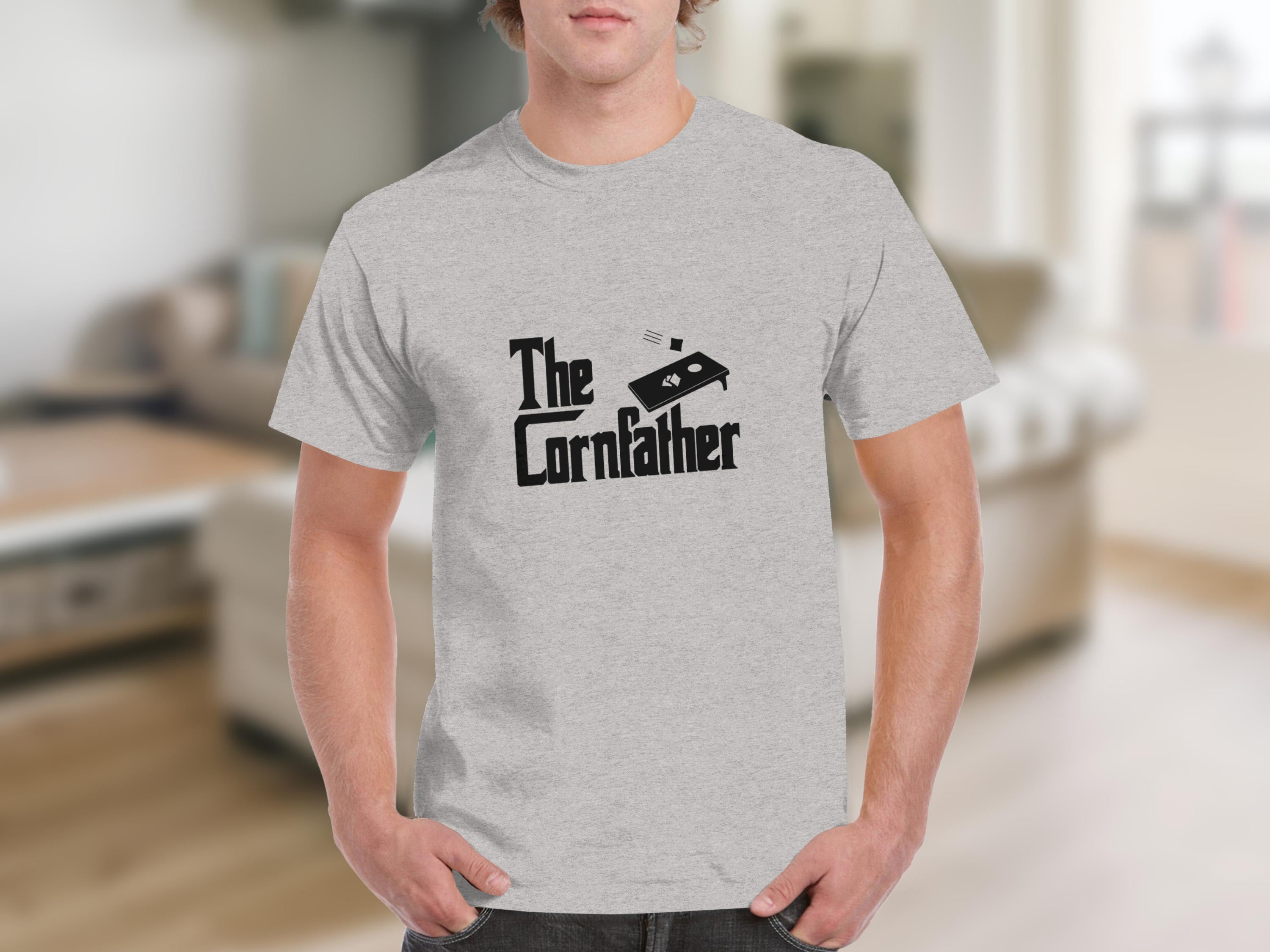 Light grey t-shirt with text "The Cornfather" and cornhole board graphic.