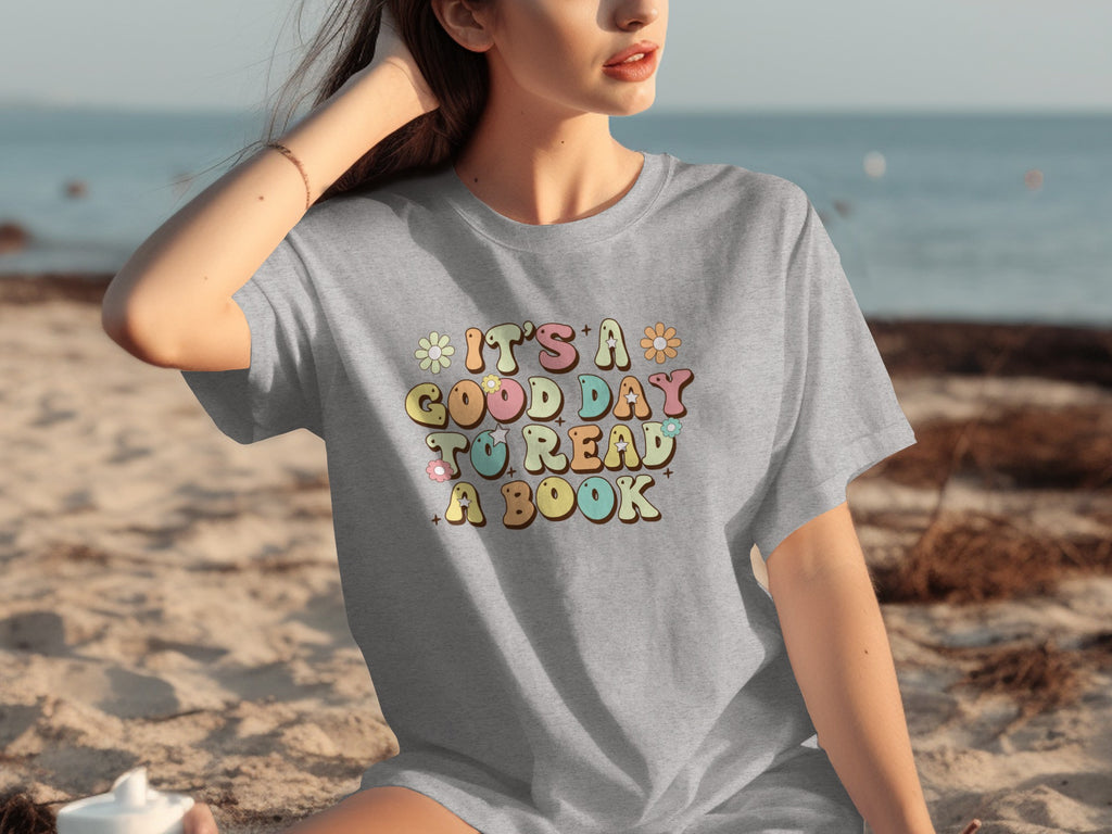 Grey t-shirt with the text "It's a good day to read a book" and floral accents.