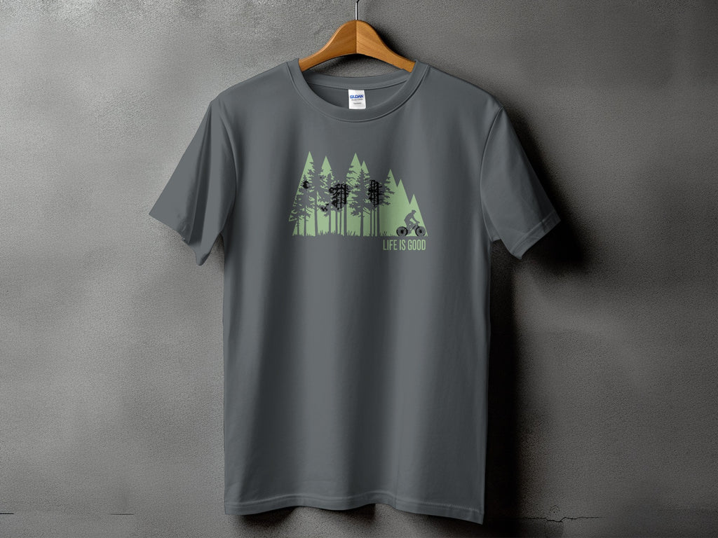 Gray t-shirt with green forest graphic and cyclist, reads "LIFE IS GOOD".