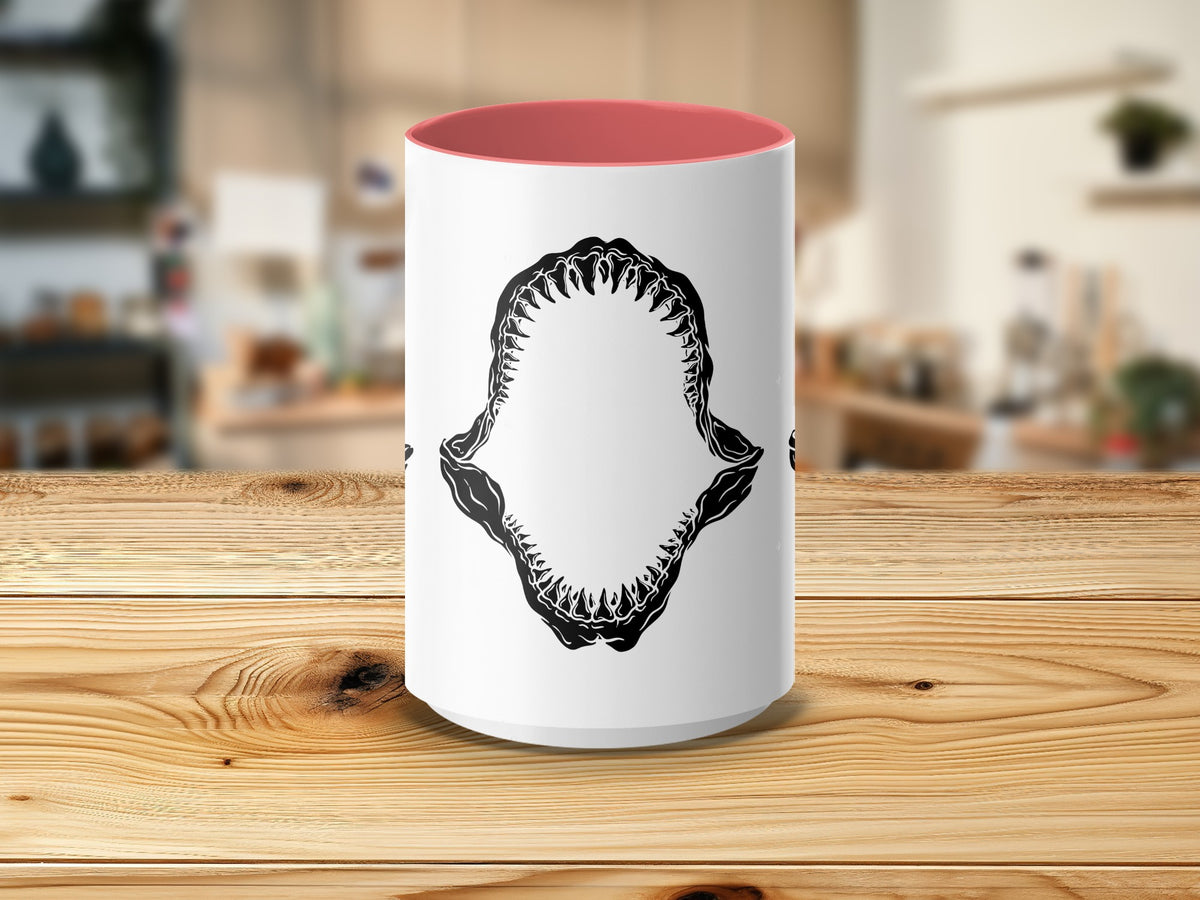 White mug with pink interior and a black shark jaw graphic.