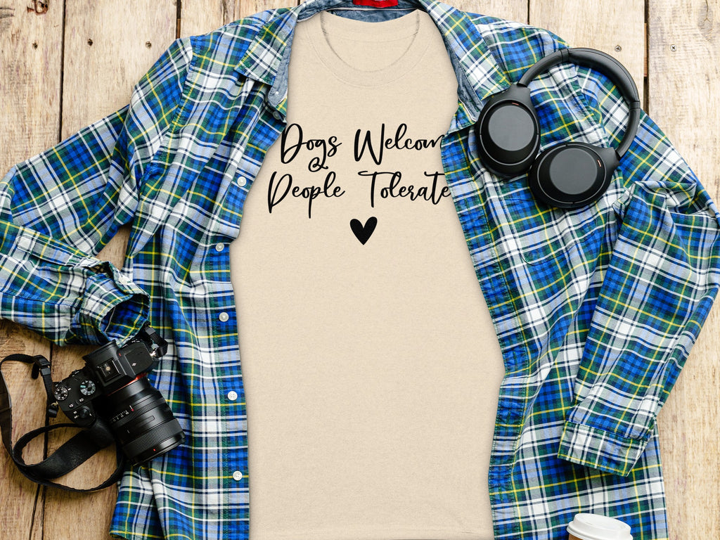 Light tan t-shirt with "Dogs Welcome, People Tolerate" text and a heart.