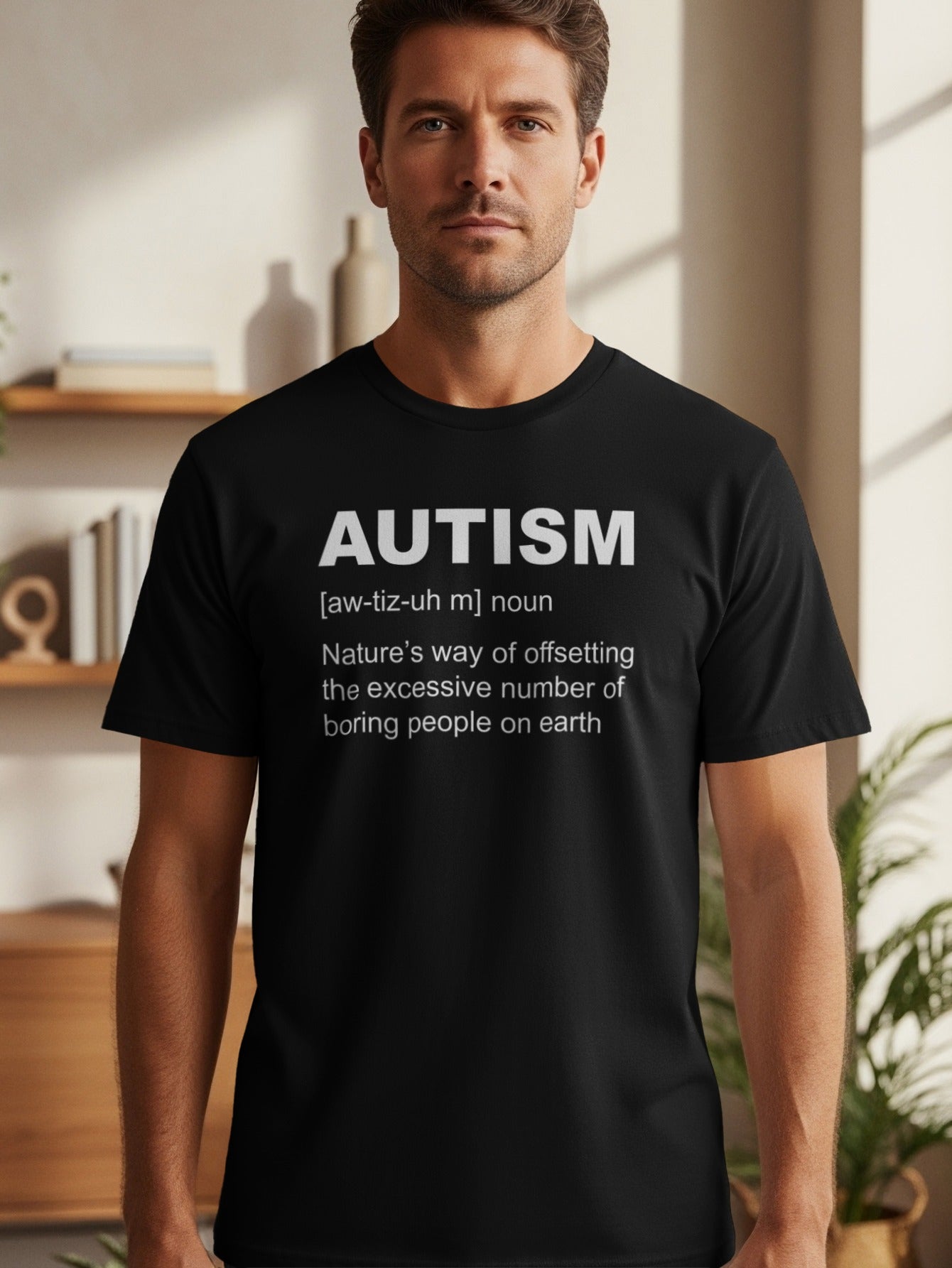 Black t-shirt with white text defining autism as "Nature's way of offsetting the excessive number of boring people on earth."