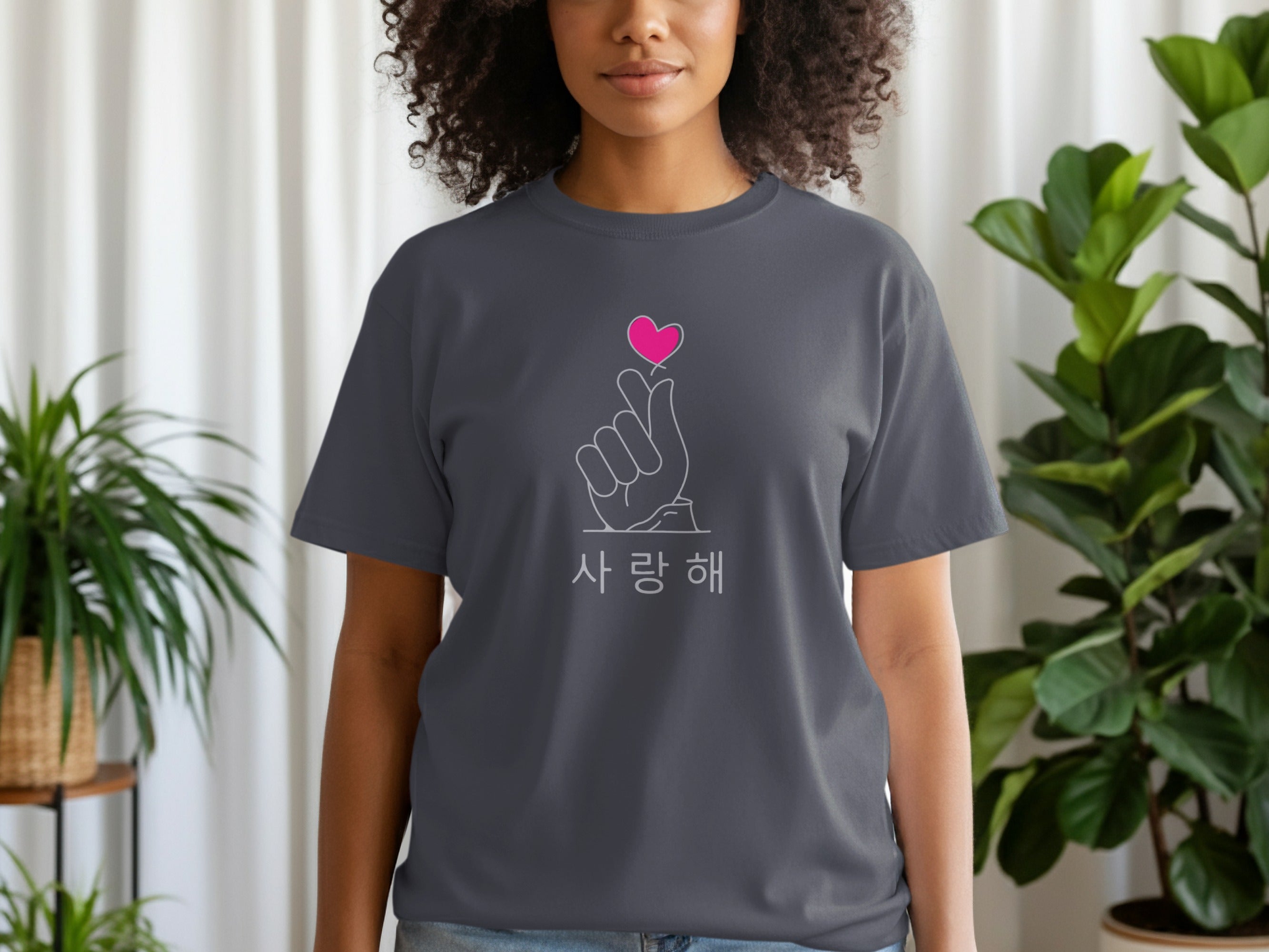 Dark grey t-shirt featuring a finger heart with a pink heart and Korean text.