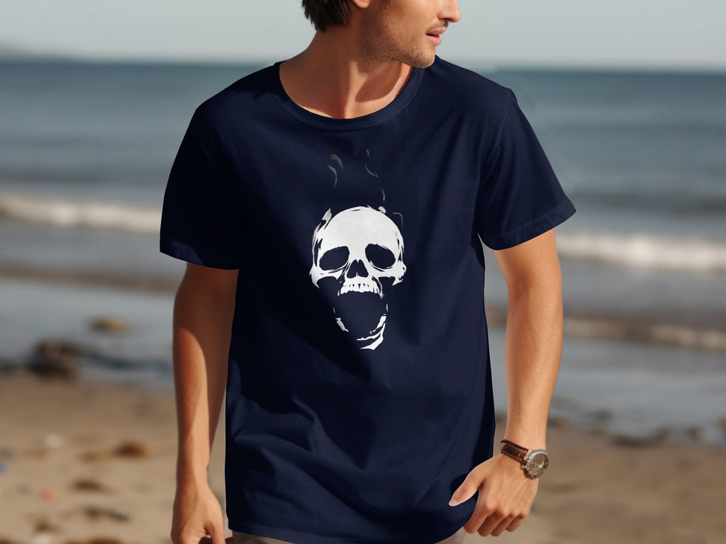 Navy t-shirt with a white screaming skull graphic, on a man at the beach.