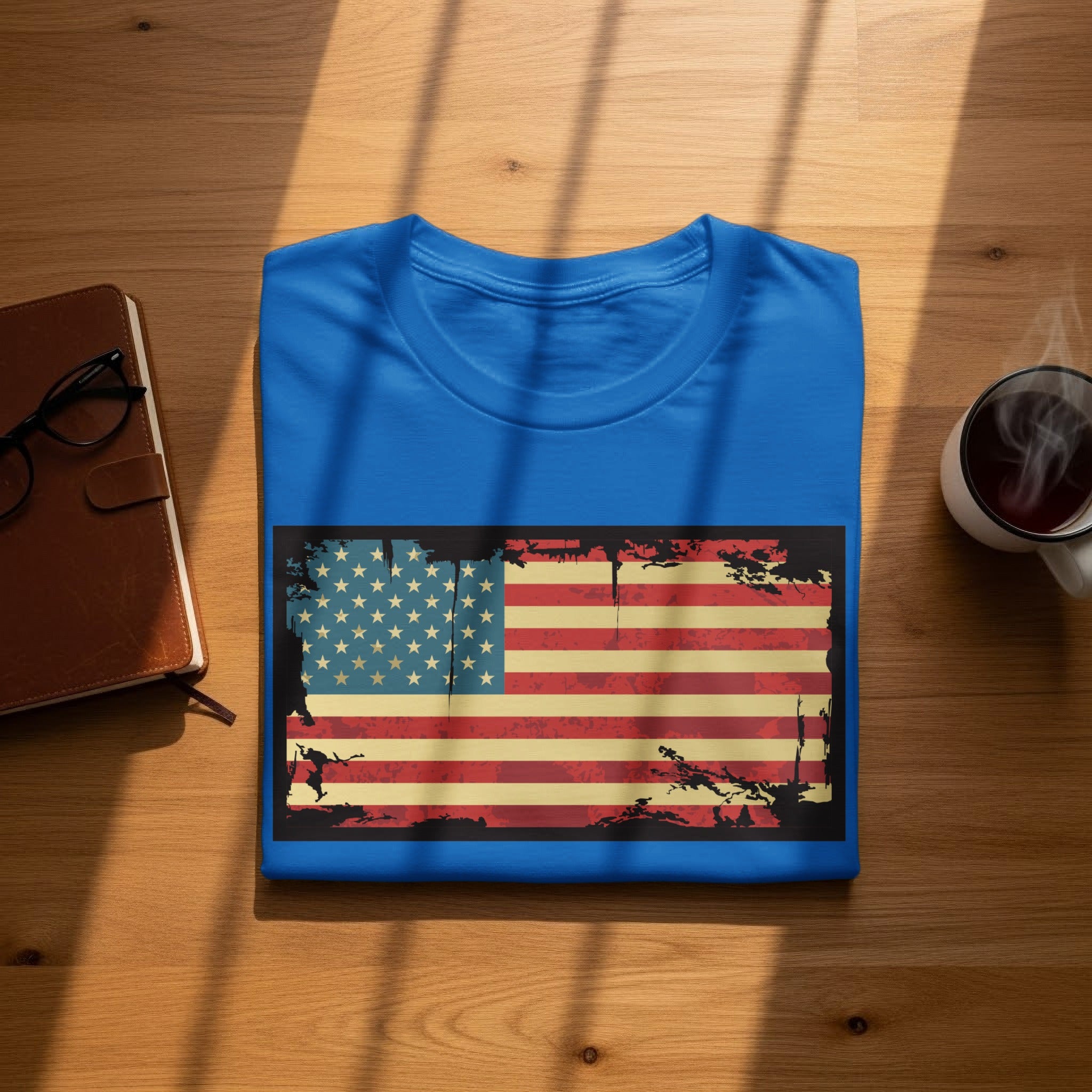 Blue t-shirt with distressed US flag graphic, on wooden surface