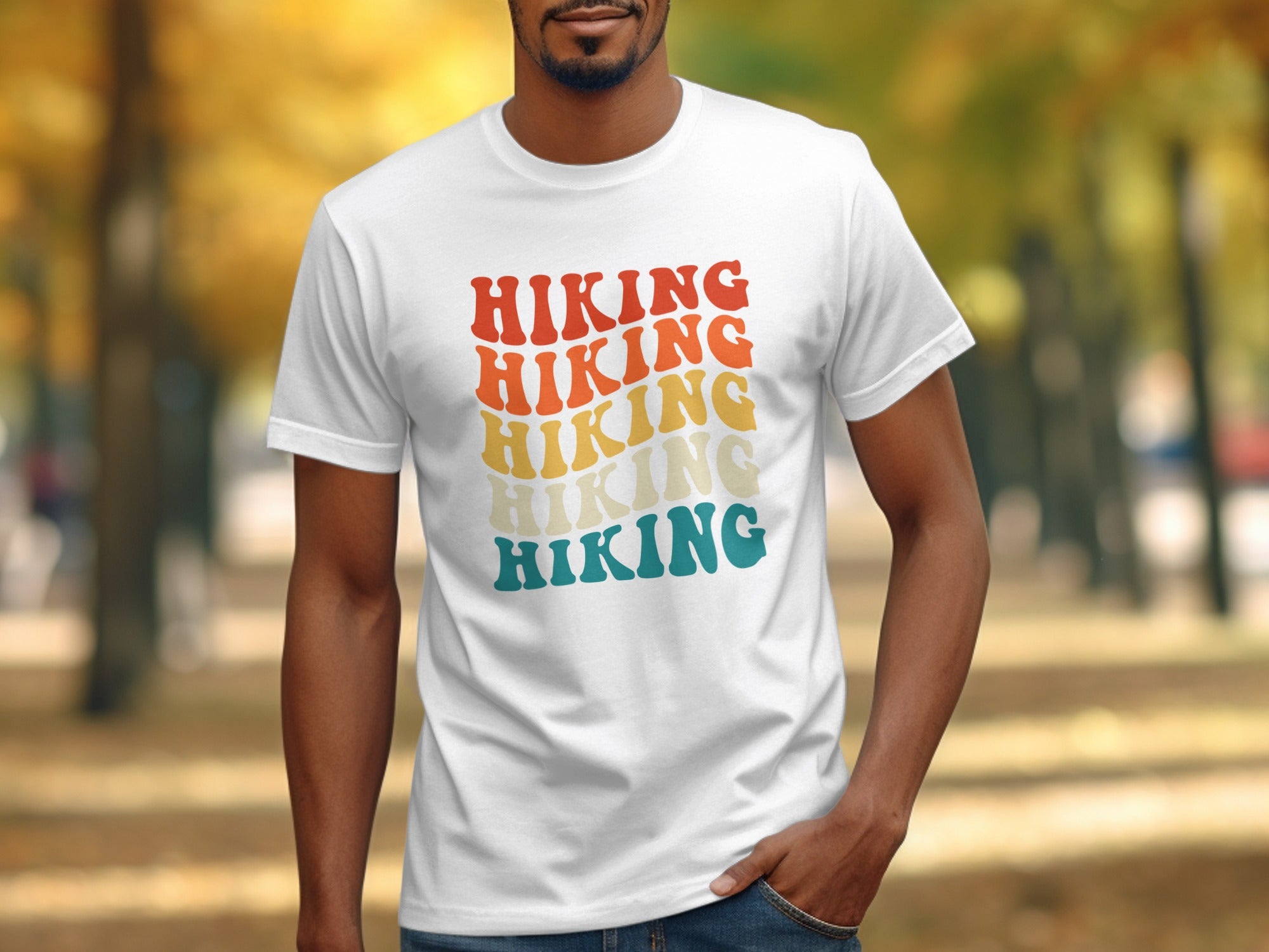 White t-shirt with repeated "Hiking" text in retro wavy font, red to blue gradient.
