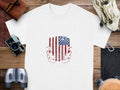 White t-shirt with distressed American flag and "Born, Raised, and Protected by God, Guns & Glory" text.