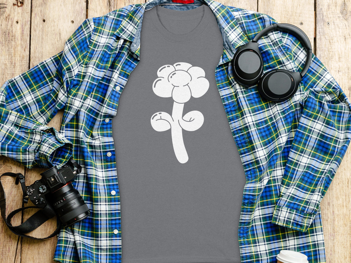 Grey t-shirt with white balloon flower design, overlaid with plaid shirt and headphones.