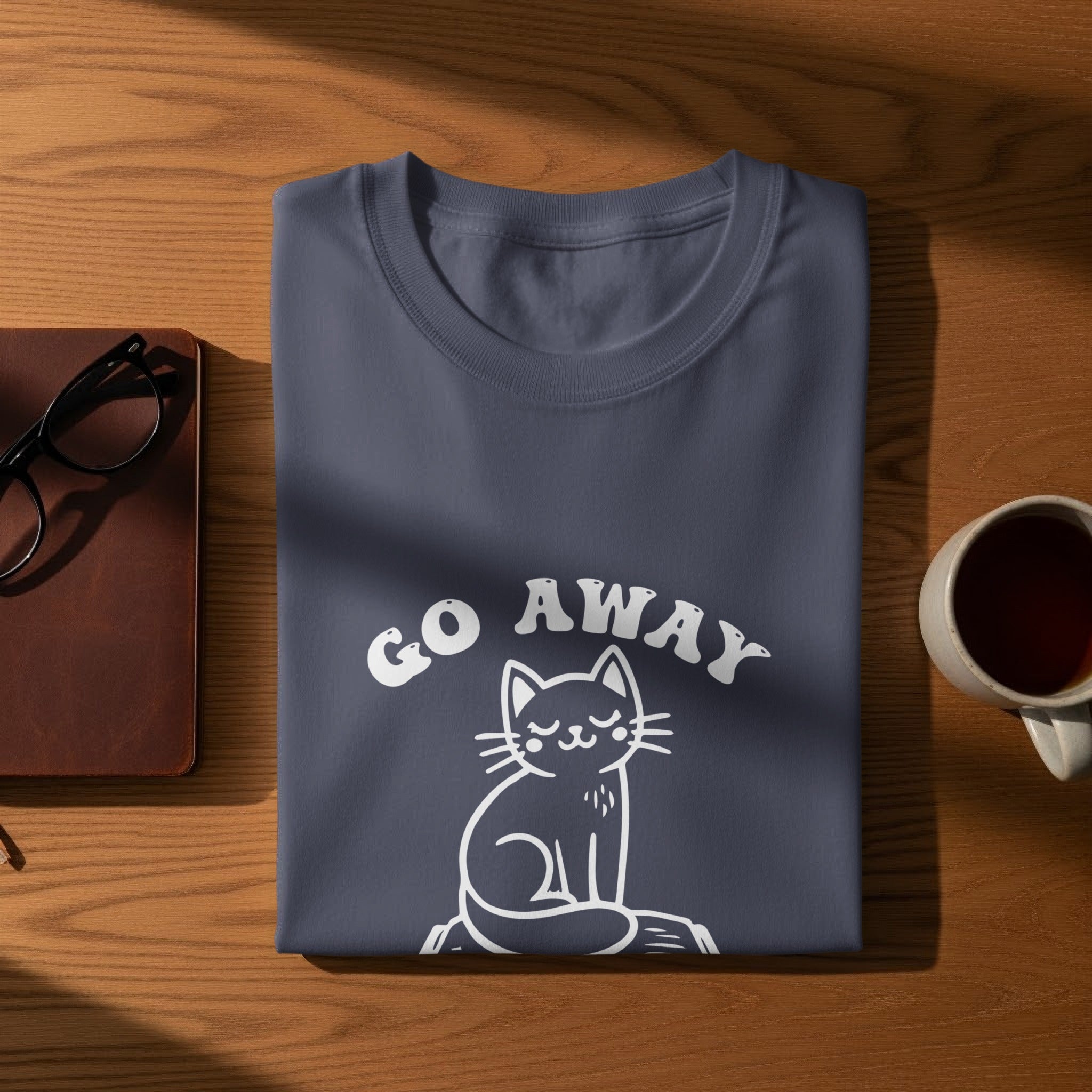Folded navy t-shirt with white text "GO AWAY" and a white cat graphic.