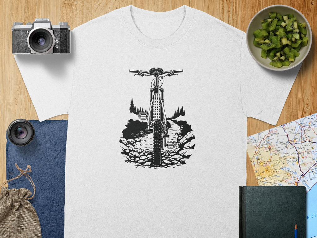 White t-shirt with black outline of mountain bike on rocky trail.