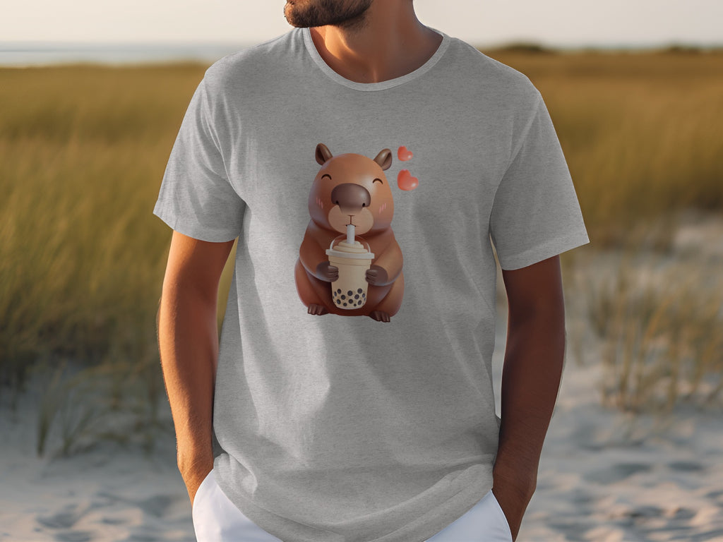 A man wearing a grey t-shirt featuring a cartoon capybara drinking boba.
