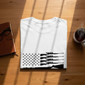 White t-shirt with black rifle silhouettes on an American flag design.