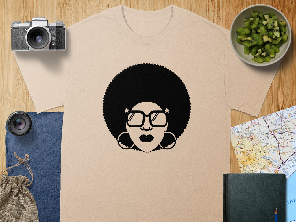 T-shirt with black afro woman graphic wearing large square glasses and hoop earrings.