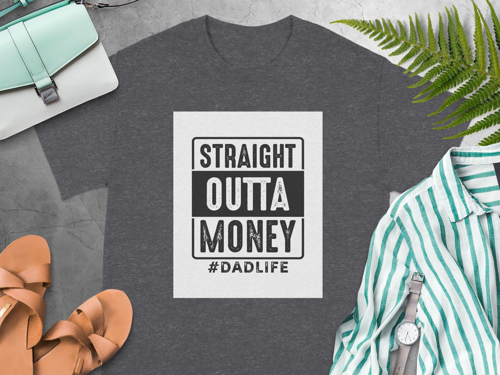 Dark grey t-shirt with "STRAIGHT OUTTA MONEY #DADLIFE" graphic.