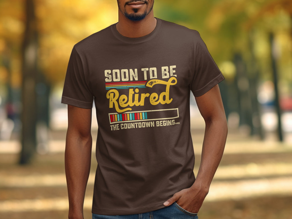 Brown t-shirt with text "SOON TO BE Retired THE COUNTDOWN BEGINS..."